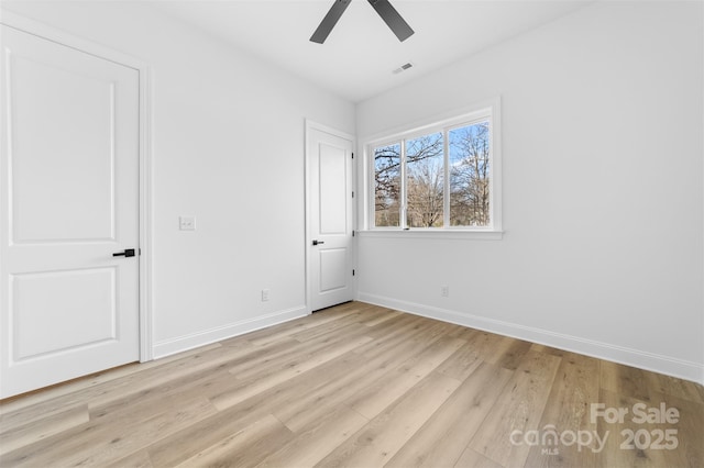 unfurnished bedroom featuring ceiling fan, light wood-type flooring, visible vents, and baseboards