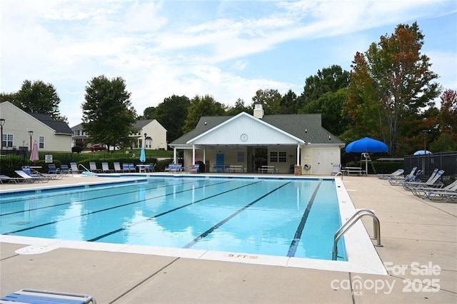 pool featuring a patio and fence