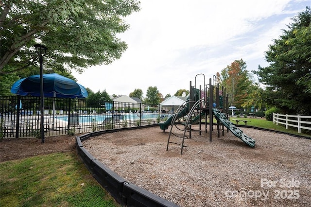 communal playground with fence and a community pool