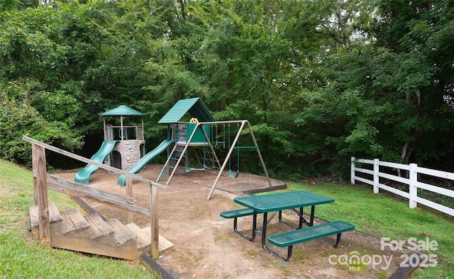 community play area with a yard and fence