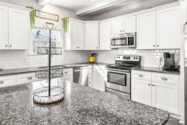 kitchen with white cabinets, stainless steel appliances, and decorative backsplash