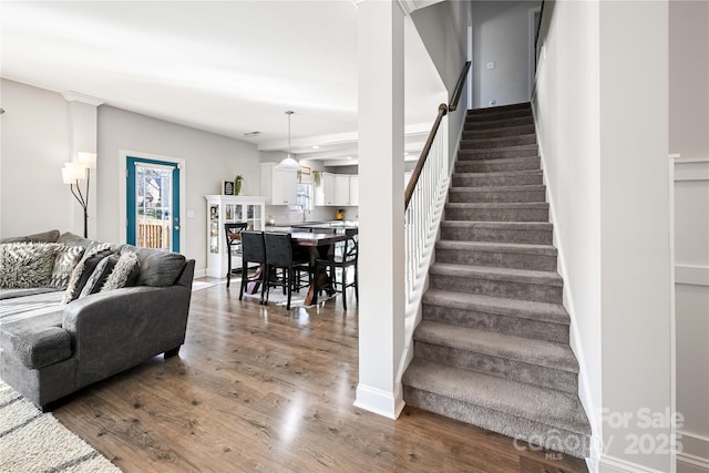 stairway featuring baseboards and wood finished floors