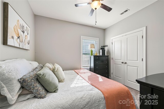 bedroom featuring ceiling fan, a closet, carpet flooring, and visible vents