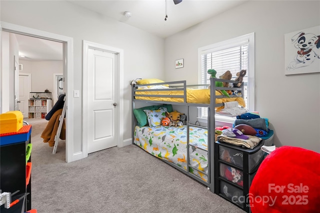 carpeted bedroom featuring baseboards