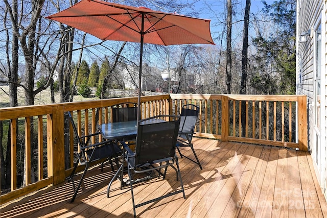 wooden deck featuring outdoor dining area