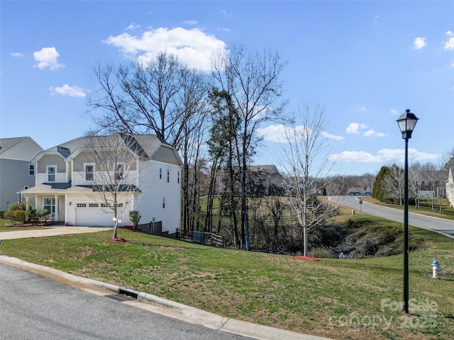 view of side of home with driveway, a garage, and a yard