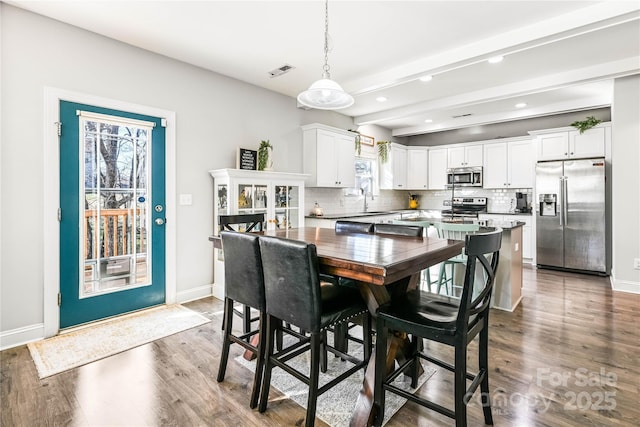 dining room with recessed lighting, wood finished floors, visible vents, and baseboards