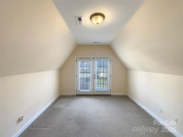 additional living space featuring lofted ceiling, carpet floors, visible vents, and baseboards