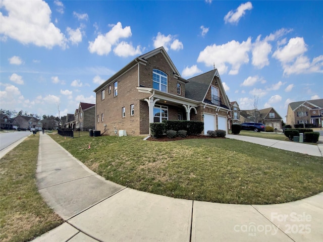 view of home's exterior featuring an attached garage, central AC, brick siding, a yard, and concrete driveway