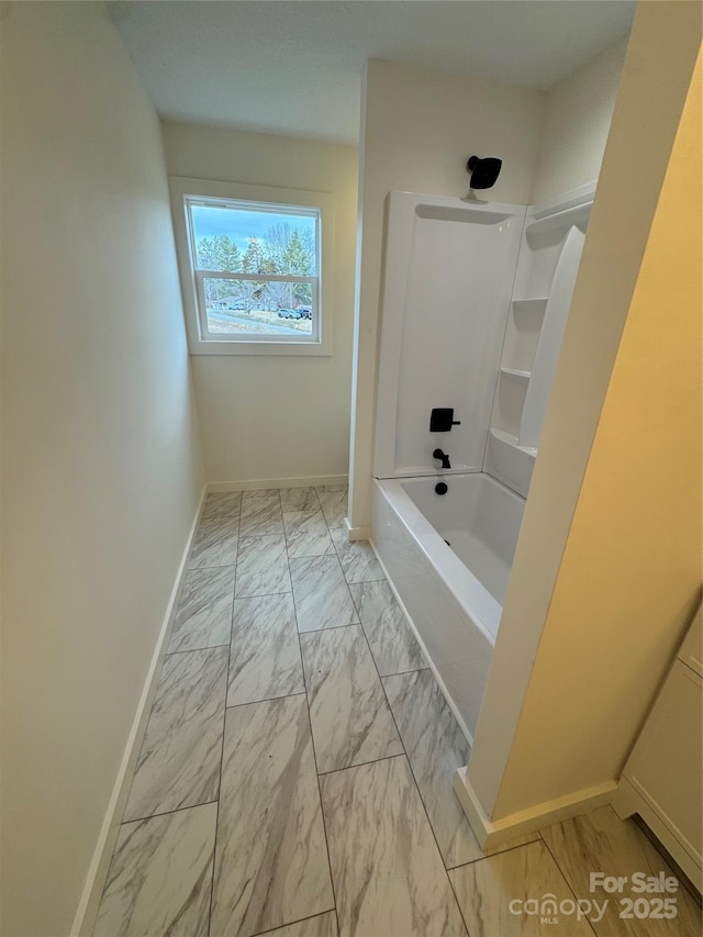 full bath featuring marble finish floor, baseboards, and bathing tub / shower combination