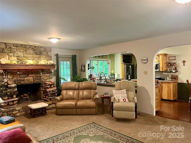 1496 Givens St, Hickory, NC 28602 - living area featuring arched walkways, dark carpet, and a fireplace