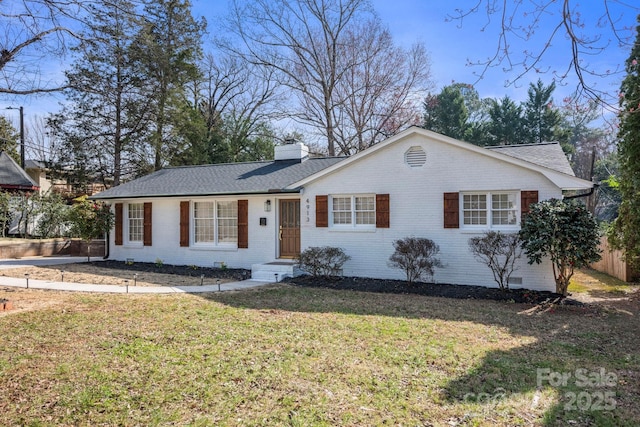 ranch-style home with brick siding, a chimney, roof with shingles, crawl space, and a front yard