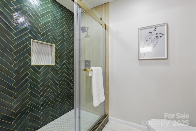 bathroom featuring toilet and a stall shower