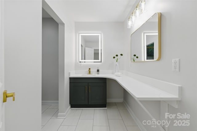 bathroom featuring baseboards, tile patterned floors, and vanity