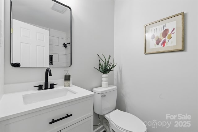 bathroom featuring toilet and vanity