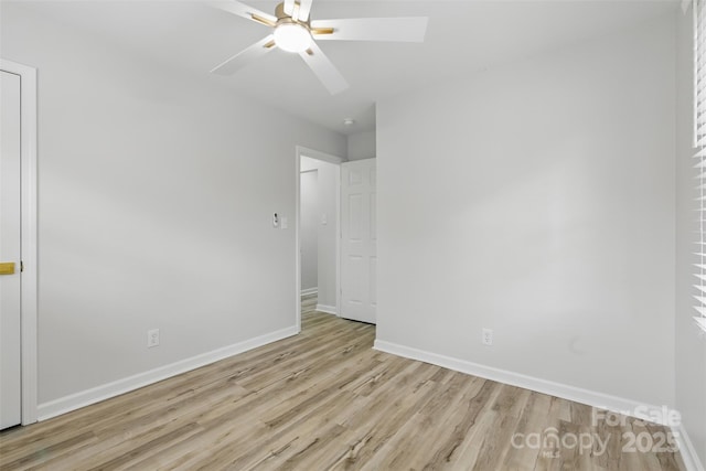 interior space with baseboards, ceiling fan, and wood finished floors