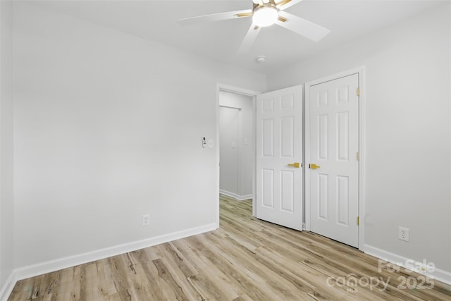 unfurnished bedroom with baseboards, light wood-type flooring, and ceiling fan