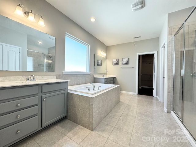 bathroom featuring visible vents, tile patterned flooring, a walk in closet, a shower stall, and a sink