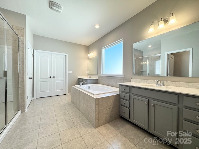 full bath with a stall shower, tile patterned flooring, a garden tub, and vanity