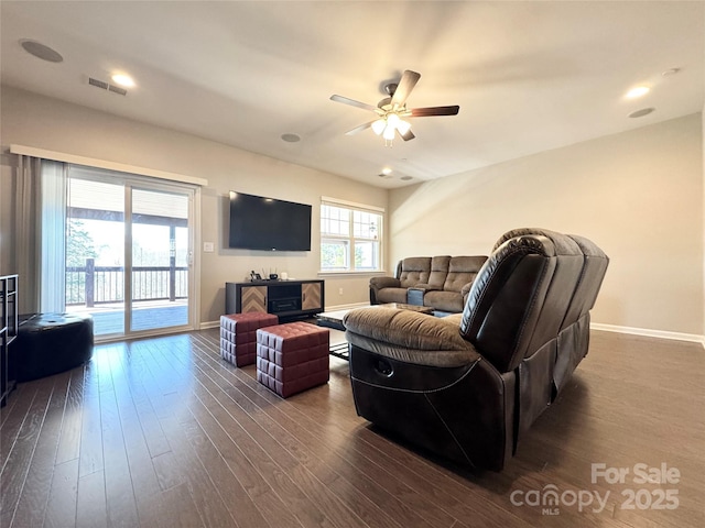 living area with dark wood-style floors, recessed lighting, visible vents, a ceiling fan, and baseboards