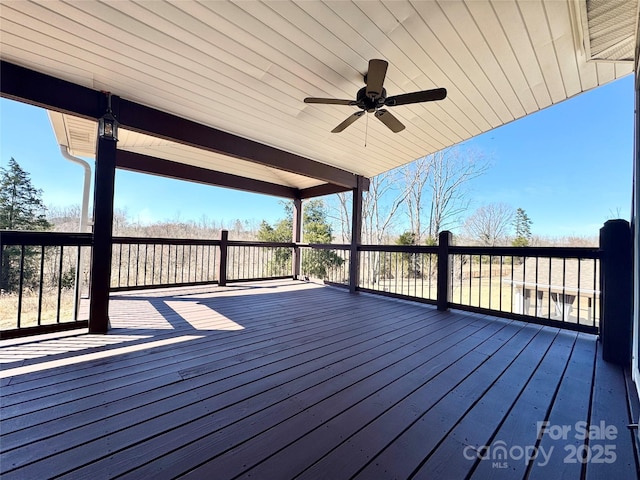 wooden deck featuring a ceiling fan