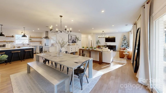 dining room featuring a notable chandelier, recessed lighting, and light wood-style floors