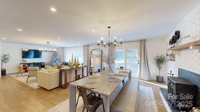 dining space featuring plenty of natural light, a notable chandelier, and light wood finished floors