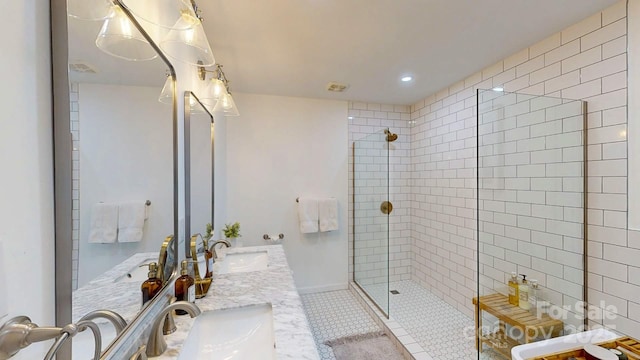 full bathroom with tile patterned floors, double vanity, a sink, and a walk in shower