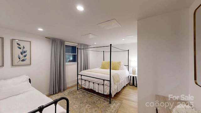 bedroom with recessed lighting and light wood-style flooring