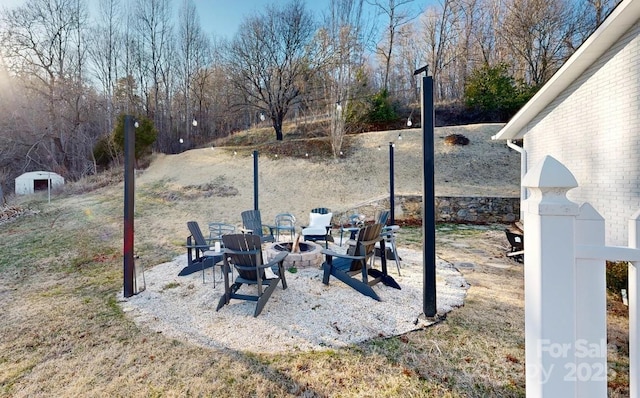 view of yard with an outdoor fire pit