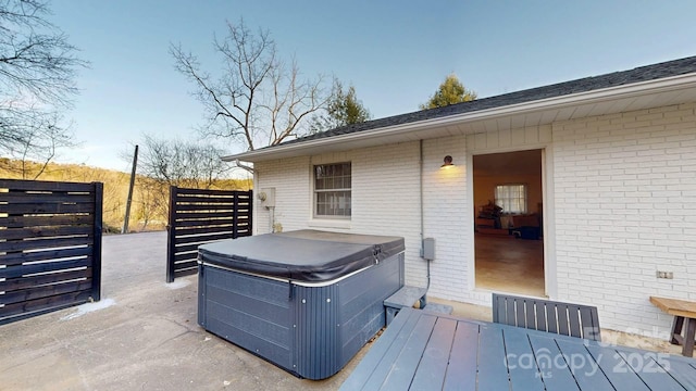 wooden deck featuring a hot tub