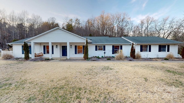 ranch-style house with a porch and a front yard