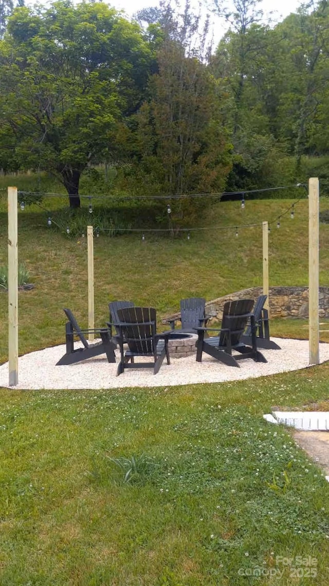 169 Chandler Rd, Alexander, NC 28701 - view of green lawn featuring an outdoor fire pit