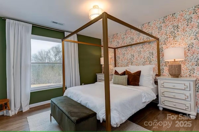169 Chandler Rd, Alexander, NC 28701 - bedroom featuring wallpapered walls, wood finished floors, multiple windows, and baseboards