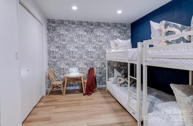 169 Chandler Rd, Alexander, NC 28701 - bedroom featuring an accent wall, wood finished floors, recessed lighting, wallpapered walls, and a closet