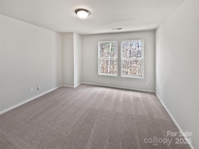 carpeted empty room with baseboards and visible vents