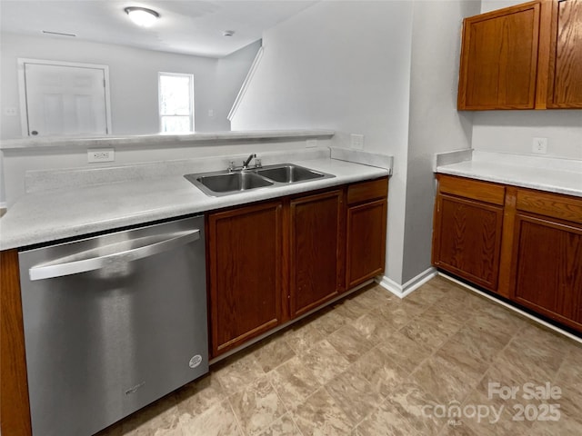 kitchen with a sink, brown cabinetry, stainless steel dishwasher, and light countertops