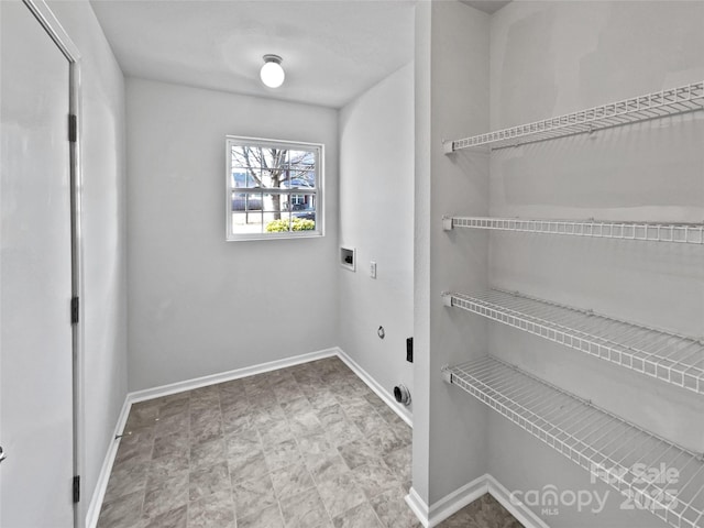 clothes washing area featuring laundry area, baseboards, and hookup for an electric dryer