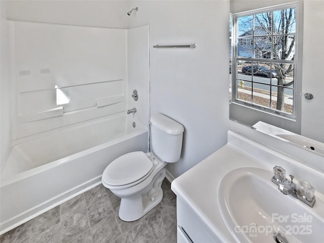 bathroom featuring a healthy amount of sunlight, toilet, tub / shower combination, and vanity