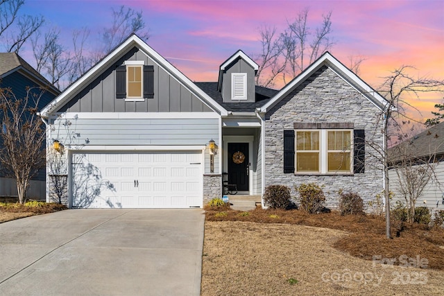 14707 Batteliere Dr, Charlotte, NC 28278 - view of front of home with board and batten siding, stone siding, driveway, and a garage