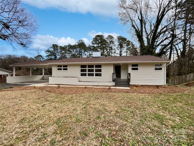 view of front facade featuring an attached carport and a front lawn