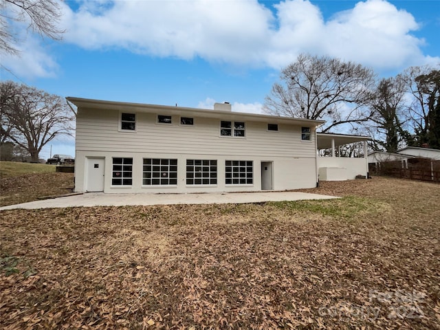 back of property with a patio and a chimney