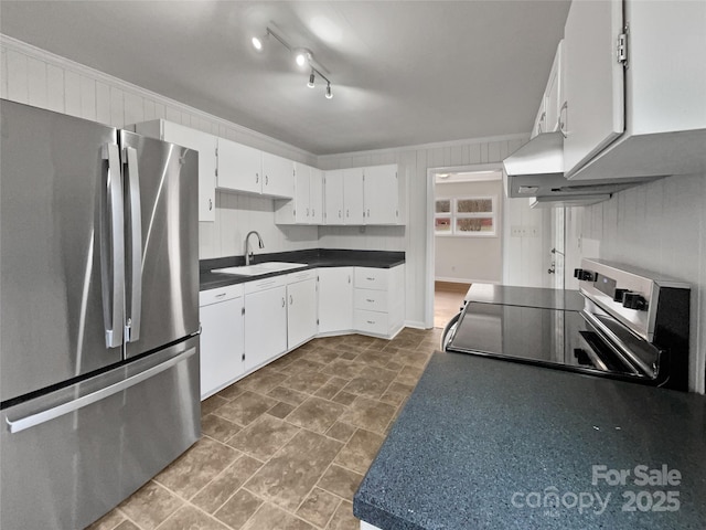 kitchen with ornamental molding, appliances with stainless steel finishes, a sink, and white cabinetry