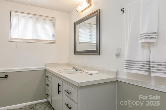 bathroom with vanity and baseboards