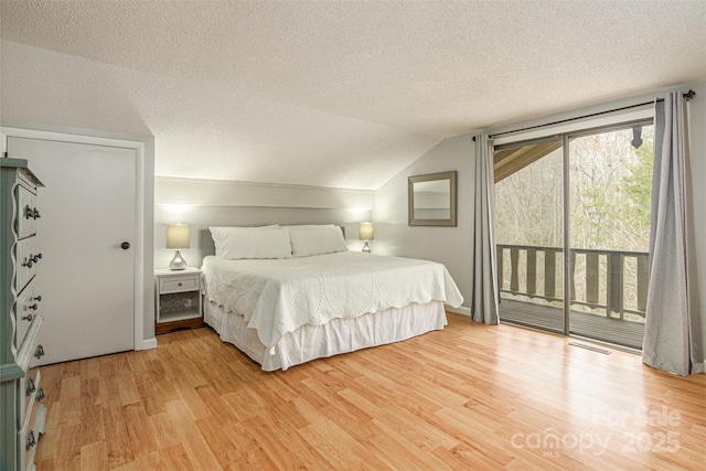 bedroom with a textured ceiling, visible vents, access to exterior, vaulted ceiling, and light wood finished floors