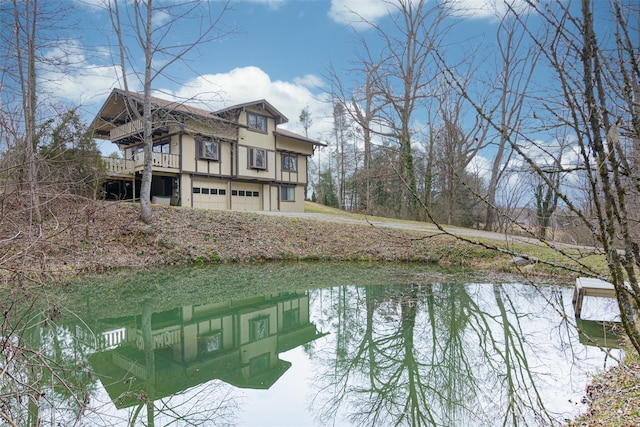 view of home's exterior with a garage and a water view