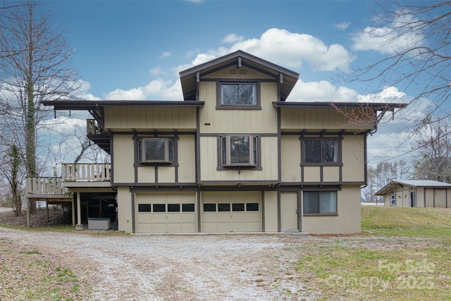 exterior space with an attached garage and dirt driveway