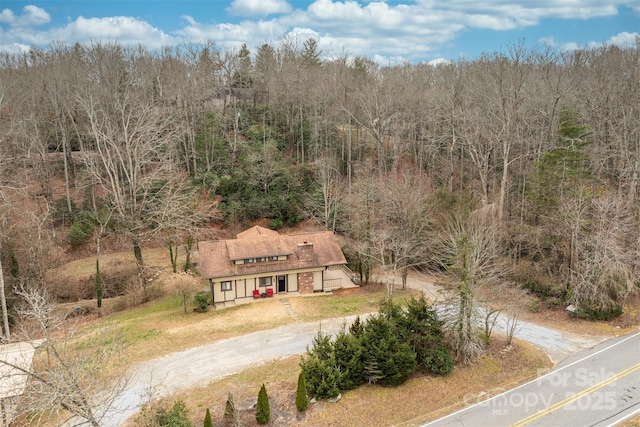 drone / aerial view with a wooded view