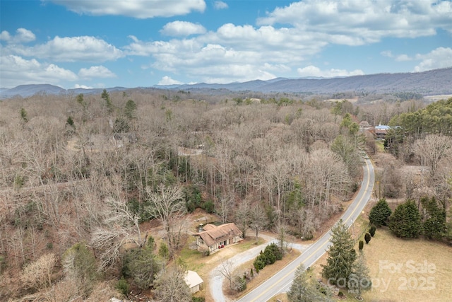 birds eye view of property featuring a mountain view and a forest view