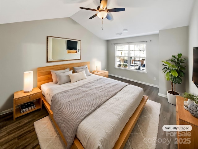 bedroom featuring ceiling fan, visible vents, baseboards, vaulted ceiling, and dark wood-style floors